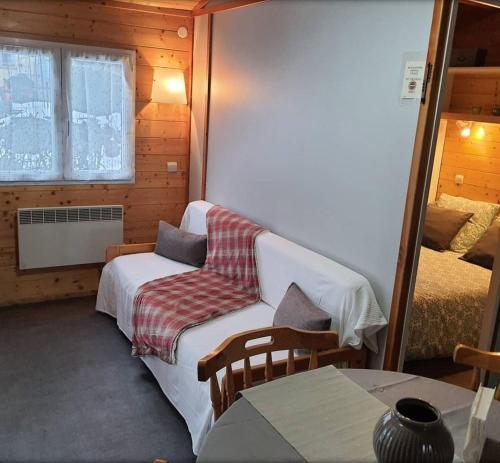 a room with a couch and a bed and a table at Chalet Beau Rivage in Gunsbach