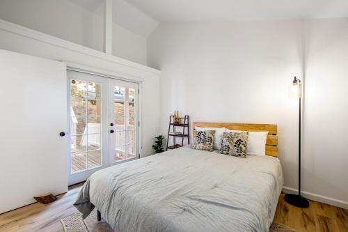 a bedroom with a bed and a large window at Red Cottage Charmer in Lake Arrowhead