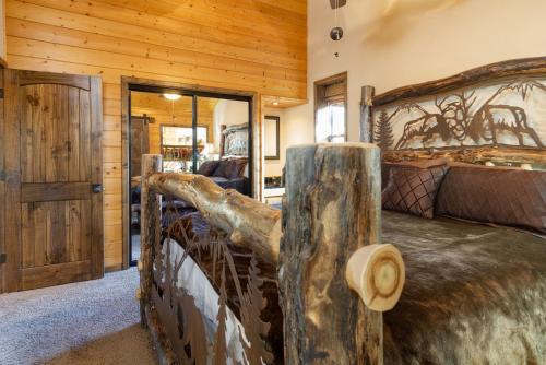 a bedroom with a bed in a log cabin at Luxury Lodge-1888 by Big Bear Vacations in Big Bear Lake