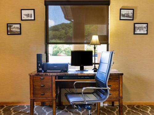 an office with a desk with a computer and a chair at Comfort Inn in Piketon