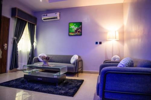 a living room with a couch and a table at Zucchini Hotel and apartments in Umueme