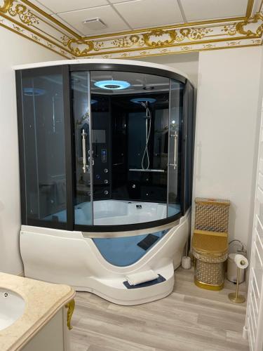 a bath tub in a bathroom with a mirror at Suite Impériale Église du Couvent in Narbonne