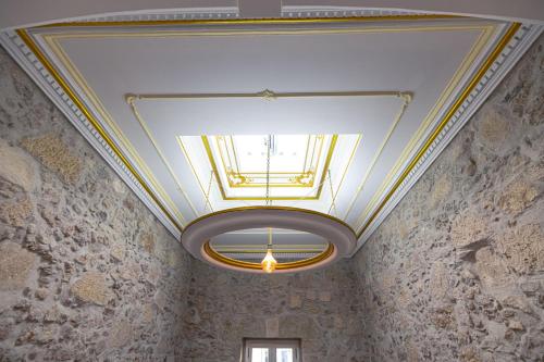 a ceiling with a light in a room at Suite Impériale Église du Couvent in Narbonne