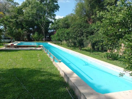 an empty swimming pool in a park with trees at Parana Riverside Guest House - Posadas in Posadas