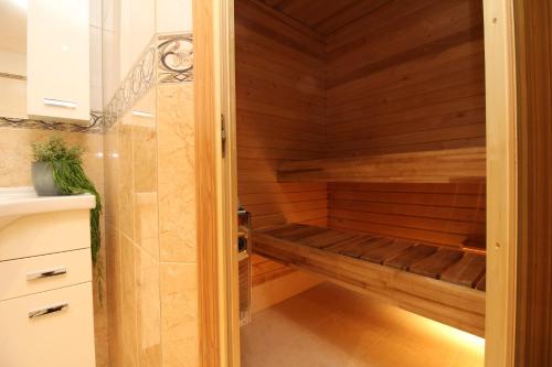 a sauna in a bathroom with wooden walls at Tallinn City Apartments - Old Town Townhouse in Tallinn
