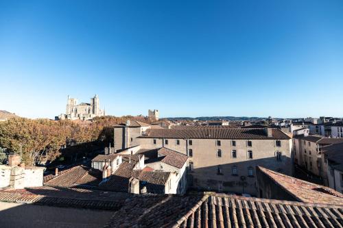 a view of a city from the roofs of buildings at Suite Impériale Église du Couvent in Narbonne