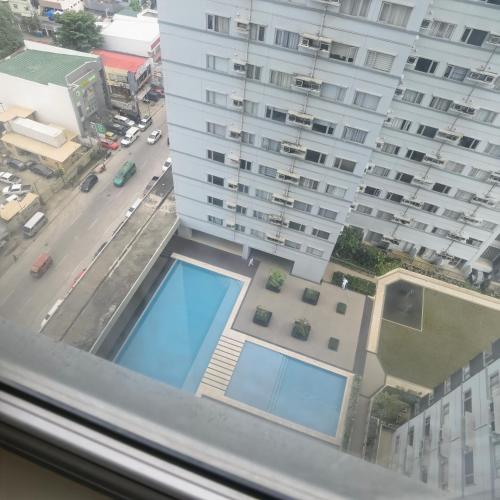 a view from a window of a building with a swimming pool at Avida Davao Condos, downtown CM Recto Avenue, Davao City in Davao City