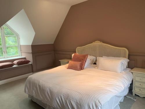 a bedroom with a bed with two pillows on it at Mount Juliet luxury residence in Ballylinch Bridge