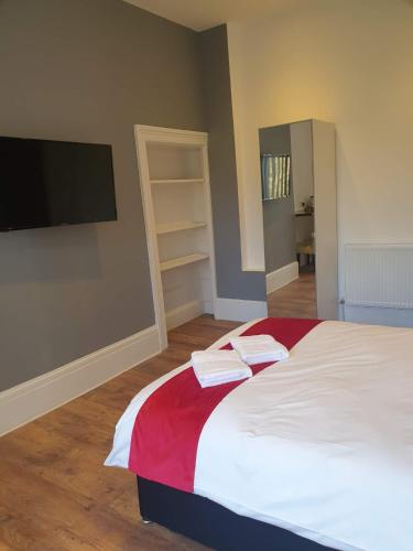 a bedroom with a bed with two towels on it at Park View in Hull