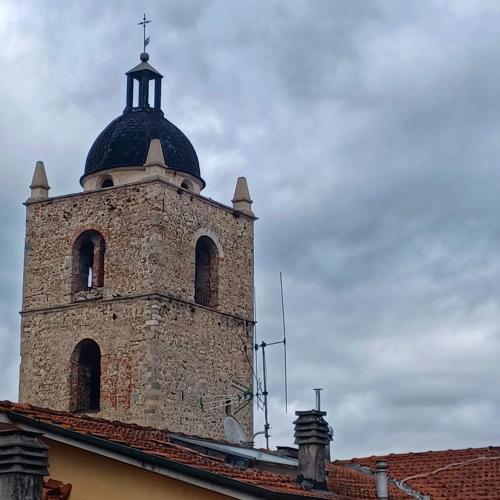 a tower with a cross on top of a building at La casa di Ciaccia in Camaiore