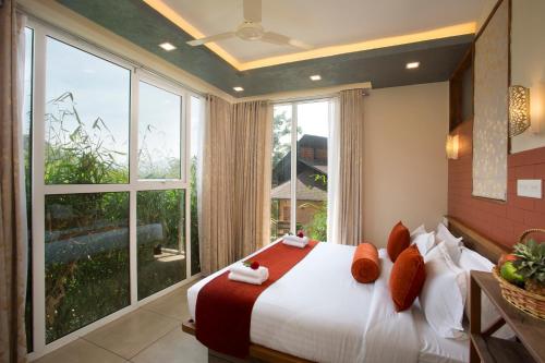 Letto o letti in una camera di Amrezy Resort and Spa by Stride, Wayanad