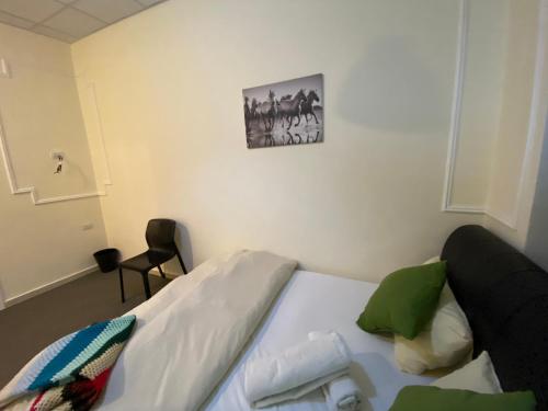 a bedroom with a bed with a picture on the wall at City Citadel Hotel,Amman in Amman