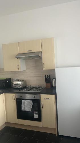 a kitchen with a stove and a refrigerator at Park View in Hull