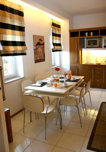 a kitchen and dining room with a table and chairs at Rota Suites in Sorrento
