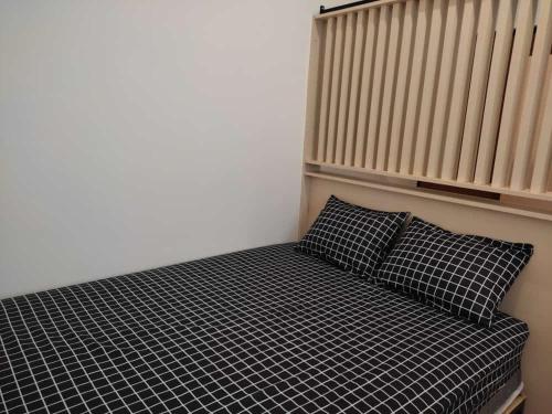 מיטה או מיטות בחדר ב-Apartemen MAJ at Ecohome Citra Raya
