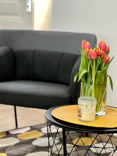 a vase of flowers on a table in a living room at Apartments Noa Old Town in Dubrovnik