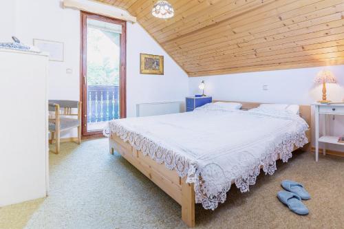 A bed or beds in a room at Panoramic Forest Chalet Bled Lake View