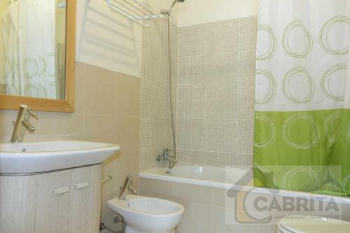 a bathroom with a sink and a toilet and a shower at Apartamento Tropical Royal Cabanas Golfe by YHA in Conceição