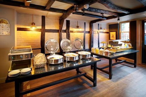 a kitchen with several pans on a table at The Merchant's House, BW Signature Collection in Salisbury
