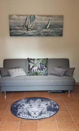 a living room with a couch and a rug at La villetta TRE PALME in Valledoria