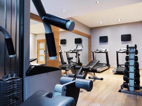 a fitness room with treadmills and cardio machines at Galaxy Iraklio Hotel in Heraklio