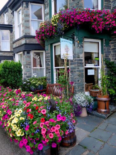 a flower shop with flowers in front of a building at Rowan Tree Guest House in Keswick