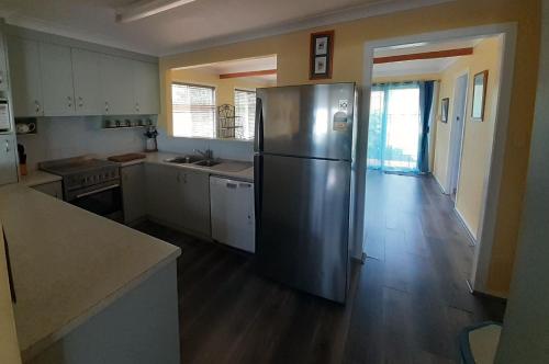 a kitchen with a stainless steel refrigerator in a room at Surf n View in North Haven
