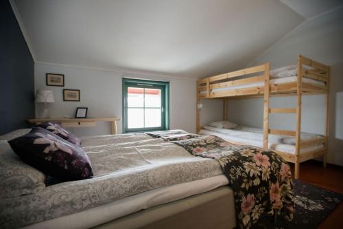 a bedroom with two bunk beds in a attic at Kajkanten Restaurang B&B in Köpmanholmen