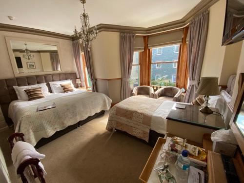 a hotel room with two beds and a window at Rowan Tree Guest House in Keswick