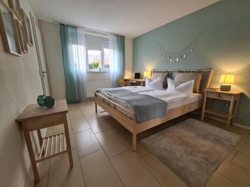 a bedroom with a large bed in a room at Neu eingerichtetes Apartment #1 mit WLAN !Sauna & Hot Tub zubuchbar! in Senftenberg