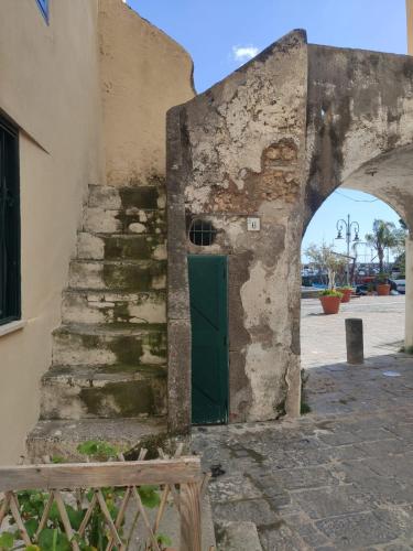 an entrance to an old building with a green door at Casa Angelica Cetara Albergo Diffuso in Cetara