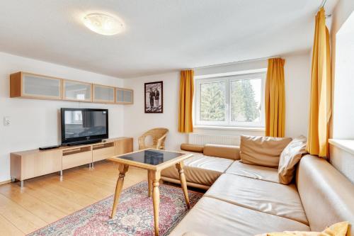 a living room with a couch and a tv at Chalet Martin in Sankt Anton am Arlberg