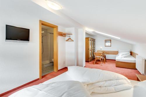 a bedroom with a bed and a tv on a wall at Chalet Martin in Sankt Anton am Arlberg