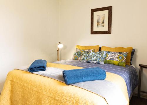 a bedroom with a bed with blue towels on it at Further Beyond in Hogsback