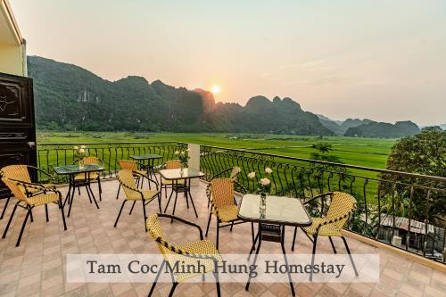a patio with tables and chairs on a balcony at Tam Coc Minh Hung Homestay in Ninh Binh