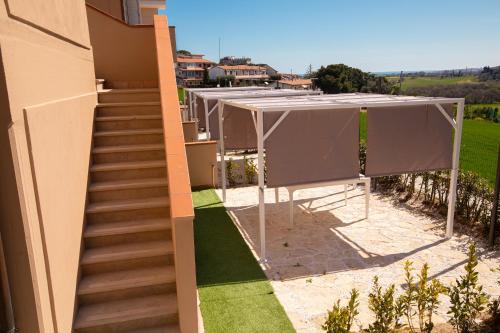 an external view of a house with a tent and stairs at Pietra Bianca Residence in Numana