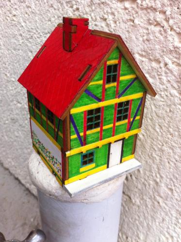 a model of a house on top of a cup at Namhae Neuhaus in Namhae