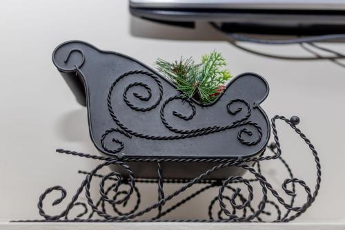 a small black bird ornament with a christmas tree at Enkarsis Resort Villa in Kitengela 