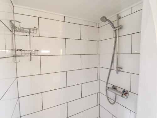 a bathroom with a shower with white tiles at The Hayloft in Skegness