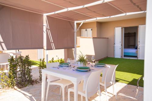 a white table and chairs on a patio at Pietra Bianca Residence in Numana