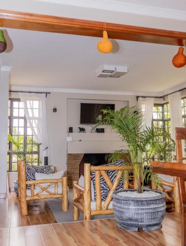 a living room with a couch and a fireplace at Enkarsis Resort Villa in Kitengela 