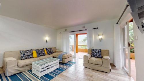 a living room with a couch and two chairs at San Lameer Villa 3002 by Top Destinations Rentals in Southbroom