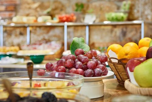 a table with a bunch of fruit on it at Hotel Al Madarig in Castellammare del Golfo