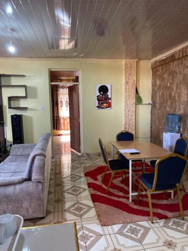 a living room with a couch and a table and chairs at Loaded homes in Kikuyu