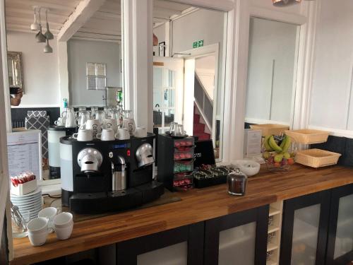 a kitchen with a coffee maker on a counter at The Fossil Tree Hotel in Blackpool
