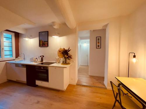 a kitchen with a sink and a counter top at Appart Hotel Jaures - Boutique apartments in Nice