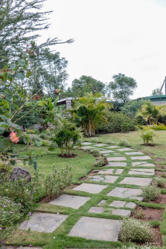 a stone path in a garden with plants at Enkarsis Resort Villa in Kitengela 