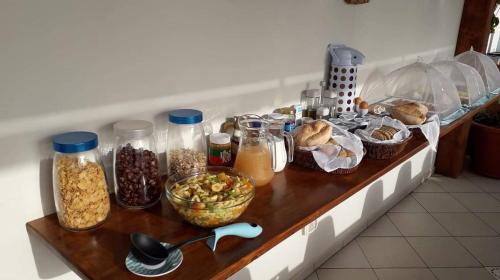 a counter with many different types of food on it at B&B Sereia Azul Boa Vista in Sal Rei
