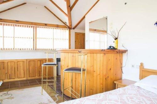 a bedroom with a bed and two stools at Park Hotel Amfora -Free Parking in Sofia