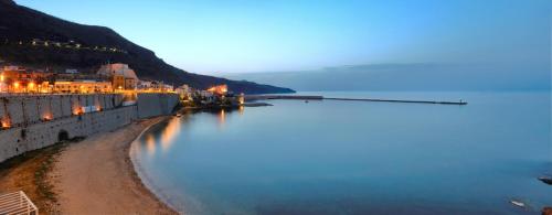a view of a body of water at night at Hotel Al Madarig in Castellammare del Golfo
